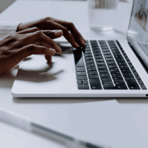 hands typing on laptop keyboard